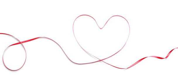 Heart made of red ribbon on white background - Foto, Imagen