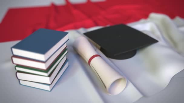 卒業キャップ、本、インドネシアの国旗の卒業証書。インドネシアの高等教育関連の概念3Dアニメーション - 映像、動画