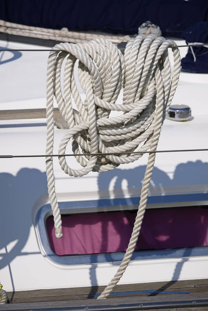 Italy, Sicily, Marina di Ragusa (Ragusa Province), nautical rope on a sailing boat in the port - 写真・画像