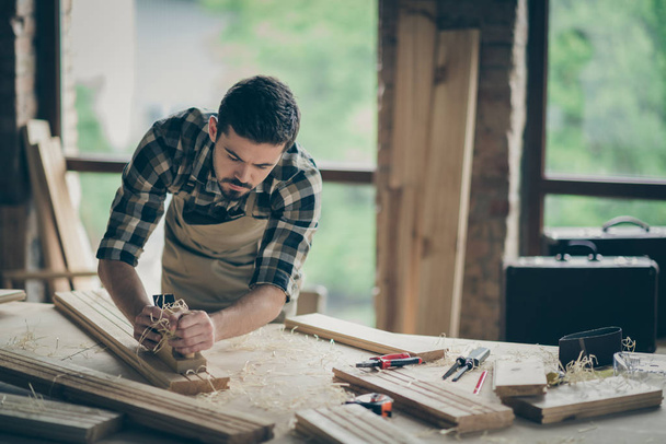 Portrait of his he nice attractive skilled hardworking guy creative self-employed engineer carving wood home-based studio manufacture at modern industrial loft brick style interior indoors - Photo, image