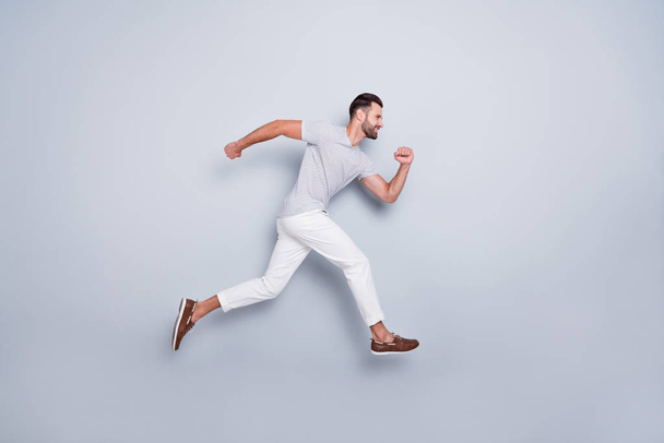 Full length body size view of his he nice attractive muscular sportive cheerful strong bearded guy running fast hurry-up isolated over light grey pastel color background - Photo, Image