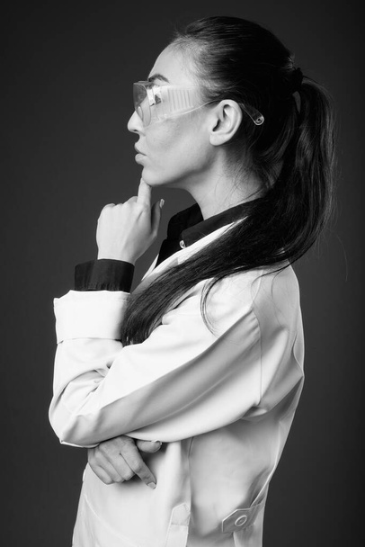 Νεαρή όμορφη γυναίκα γιατρός φοράει προστατευτικά γυαλιά - Φωτογραφία, εικόνα