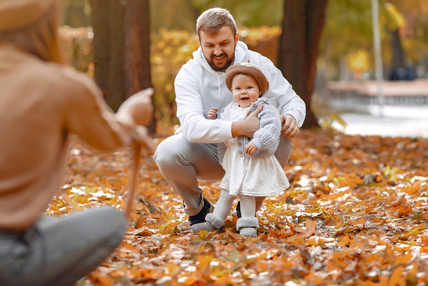 Family with little daughter in a autumn park - Photo, Image