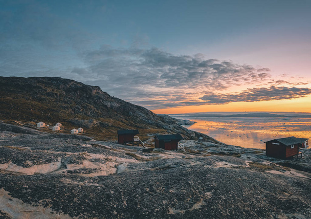 Panoramic image of Camp Eqi at Eqip Sermia Glacier in Greenland. nature landscape with lodge cabins. Midnight sun and pink sky. Tourist destination Eqi glacier in West Greenland AKA Ilulissat and - Photo, image