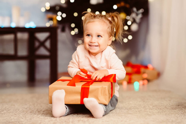 Happy baby girl enjoying Christmas gift at home - Photo, Image