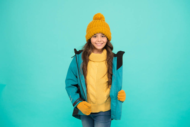 Winter sports. knitted clothes fashion. cold season weather. outdoor activity for kids. small girl sweater. hat and gloves accessory. warm clothes sales. happy girl down jacket. Winter holidays - Φωτογραφία, εικόνα