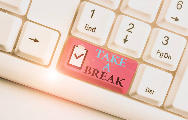 Writing note showing Take A Break. Business photo showcasing Resting Stop doing something recreation time get out of work White pc keyboard with note paper above the white background. - Photo, Image