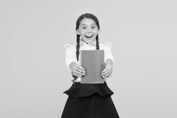 best book. small girl in school uniform. reading story. childrens literature. kid learning grammar. back to school. dictionary notebook. Get information. cheerful girl with workbook. Education - Fotó, kép