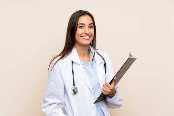 Jeune médecin femme sur fond isolé tenant un dossier
 - Photo, image