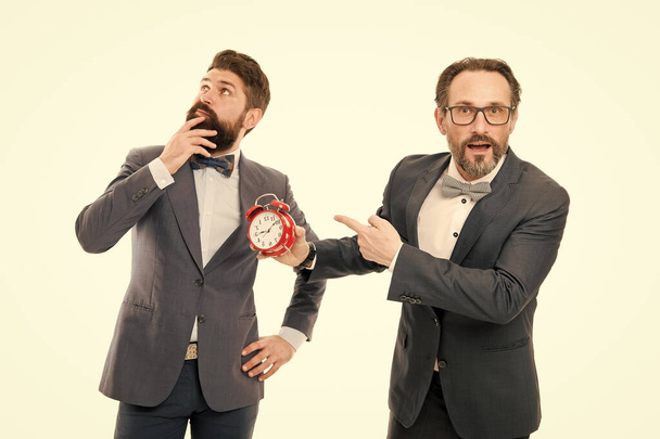 late again. angry businessmen. bad morning. a lot of work. time management. mature bearded men in formal suit hold alarm clock. deadline. on ho. rush hour. working overtime. dreaming about vacation - 写真・画像