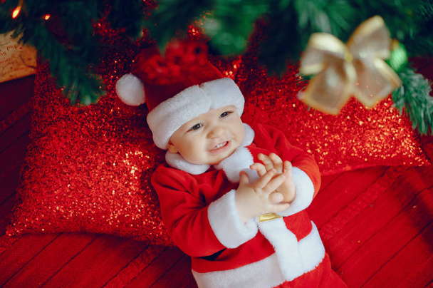 Cutte little boy at home near christmas decorations - Foto, imagen