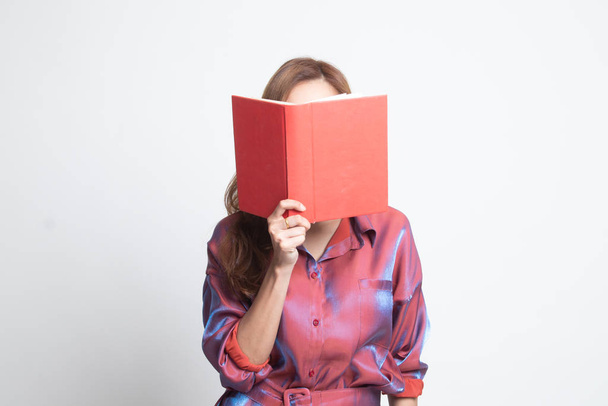 Young Asian woman with a book cover her face. - Foto, Imagem