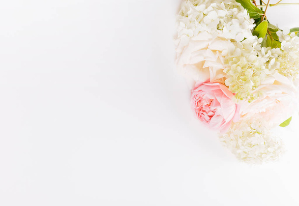 Festive flower composition on the white wooden background. Overhead view - Φωτογραφία, εικόνα