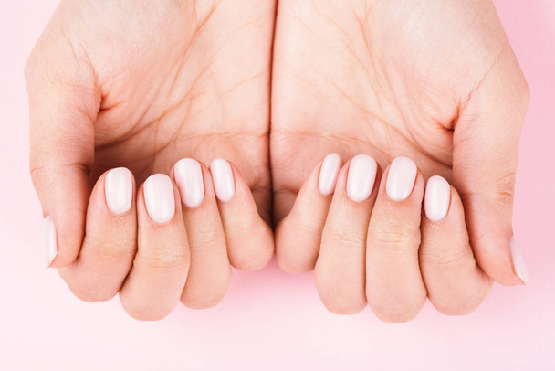 Females hands with classic pastel manicure. - 写真・画像