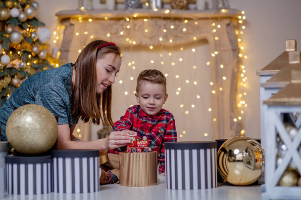 Holidays and presents concept - Close-up of family opening gifts at Christmas time - 写真・画像