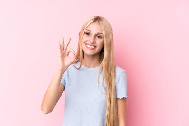 Young blonde woman on pink background cheerful and confident showing ok gesture. - Fotoğraf, Görsel