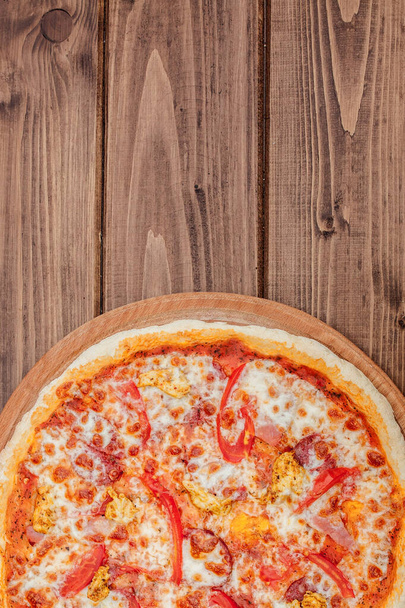 Pizza with Mozzarella cheese, salami, Tomatoes, pepper, Spices. Italian pizza - 写真・画像