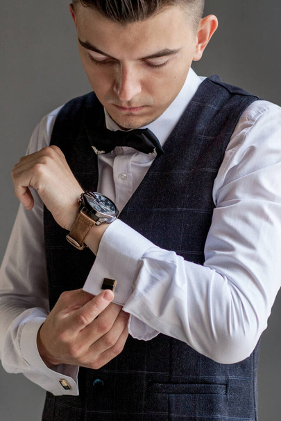 Man gets ready for work by buttoning up his business shirt. Groom's morning preparation before wedding - Φωτογραφία, εικόνα