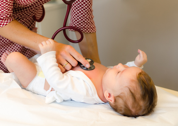 Doctor exams infant with stethoscope - Photo, Image