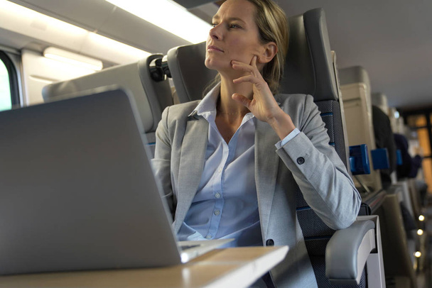 businesswoman working on a train in business class - Foto, Imagem