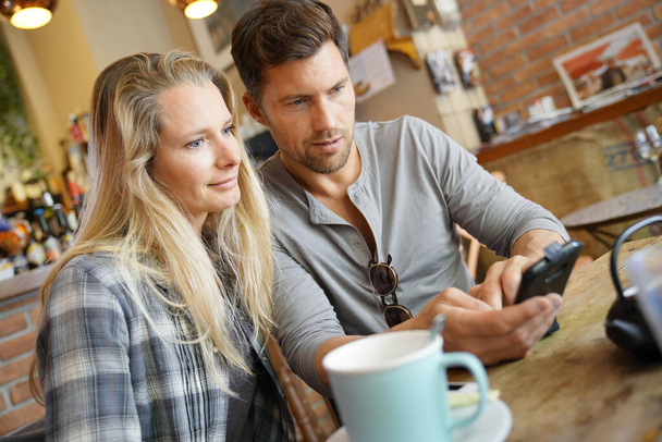 Middle-aged couple sitting at coffee shop  - Valokuva, kuva