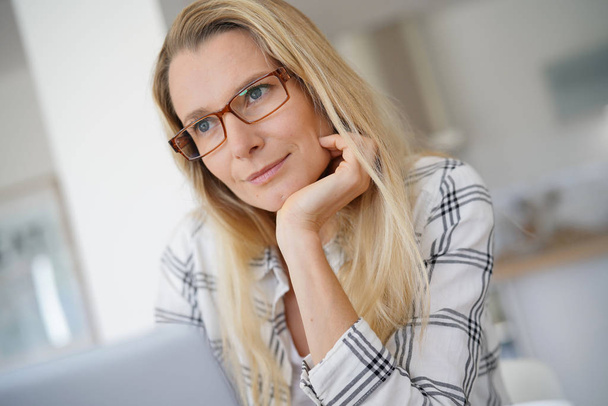 young woman with glasses working in front of her computer - Фото, зображення
