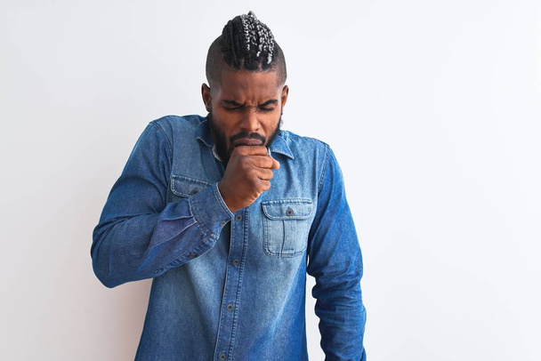 African american man with braids wearing denim shirt over isolated white background feeling unwell and coughing as symptom for cold or bronchitis. Healthcare concept. - Photo, Image