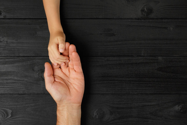 Adult hands holding kid hands - Photo, Image