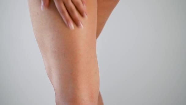 Woman rubs anti-cellulite cream on legs and buttocks skin - Footage, Video
