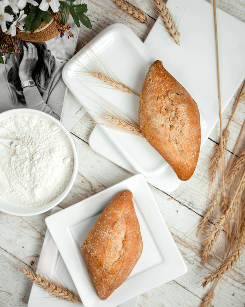 bakery with sour cream and wheat branch on the table - Φωτογραφία, εικόνα