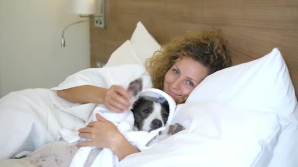 Beautiful Woman Resting In Bed With Dog In Bathrobe - Footage, Video