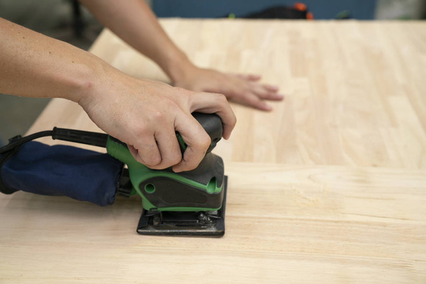 carpenter scrubbing wood board in the workshop, diy and repair c - Фото, изображение