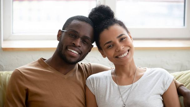 Portrait of happy biracial couple posing for picture hugging - Photo, Image