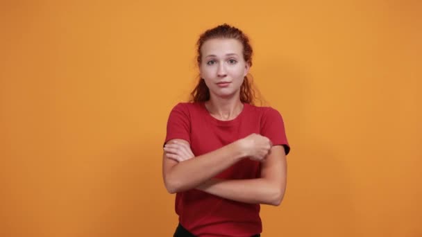 Smiling young lady in red shirt keeping hands crossed, laughting - Materiaali, video