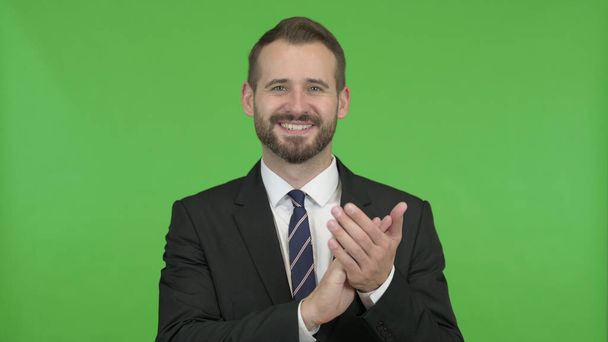 The Cheerful Businessman clapping with both hands against Chroma Key - Foto, Imagen
