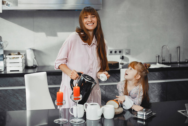 Mother with daughter in a kitchen - Photo, Image