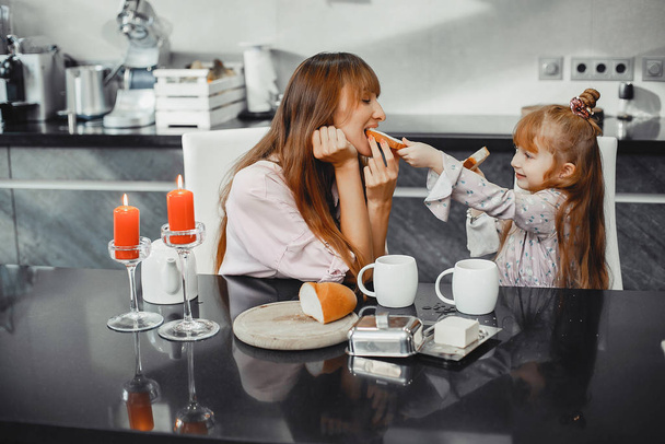 Mother with daughter in a kitchen - Foto, imagen