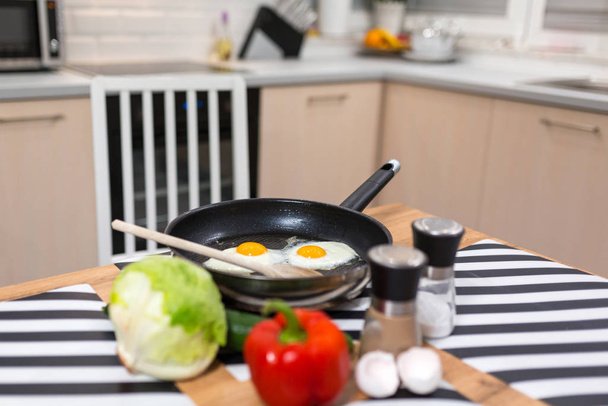 Fried eggs on pan in the kitchen - Фото, зображення