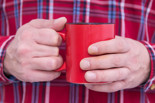 man in plaid shirt with cup in hand - Photo, image