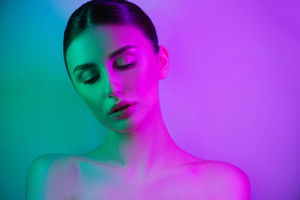 High Fashion woman in colorful bright neon uv blue and purple lights, posing in studio - Fotoğraf, Görsel