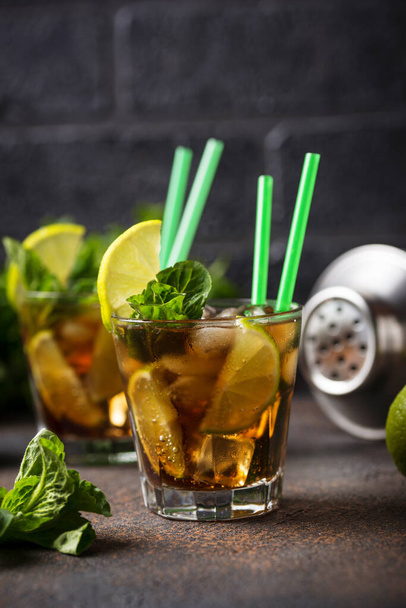 Cuba libre cocktail with mint and lime - Fotoğraf, Görsel