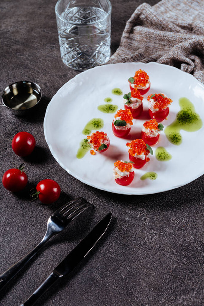 Three stuffed tomatoes on a white plate - Valokuva, kuva