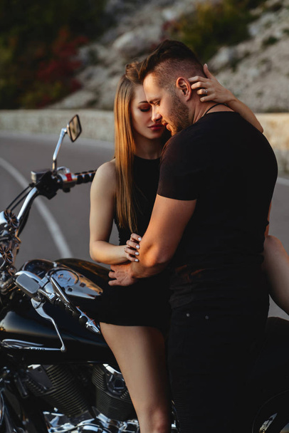 Portrait of beautiful young couple on a motorcycle. - Фото, зображення