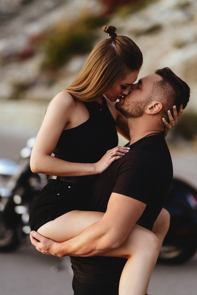 Couple of lovers kissing and hugging on motorbike - Foto, imagen