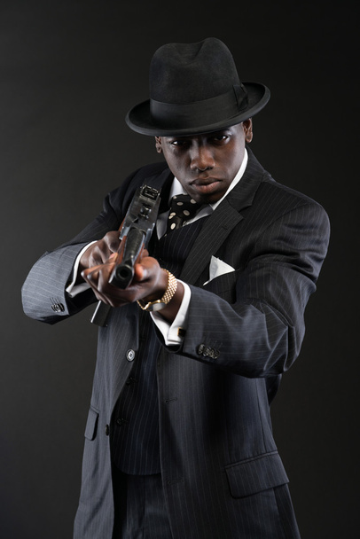 Retro afrikkalainen amerikkalainen mafia mies yllään raidallinen puku ja solmio
 - Valokuva, kuva