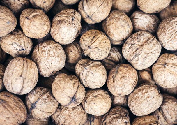 Natural walnut in shell background pattern texture. - Фото, изображение