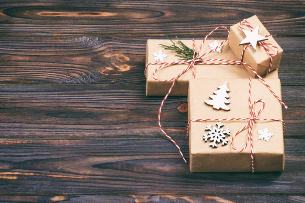 Christmas gift box with copy space. Xmas present boxwith decoration on wooden background. Toned - Φωτογραφία, εικόνα