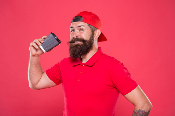 tastes perfect. brutal stylish barista. energy concept. hipster barista red background. barista job. coffee shop advertisement. take away drink. be active whole day. bearded man drink morning coffee - Foto, Imagem