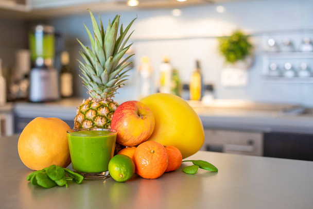 Different tropical fruits and smoothie on home kitchen background, healthy eating lifestyle concept - Zdjęcie, obraz