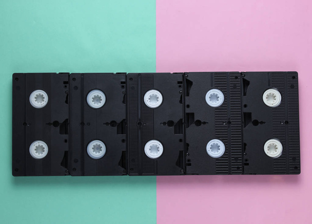 A lot of video tapes on pastel background. Top view - Photo, Image